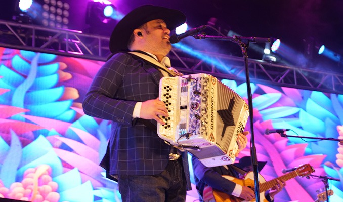 Intocable performance at a music festival